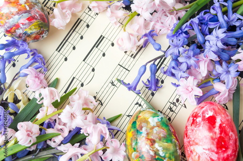 Easter eggs and hyacinth flowers on music sheets