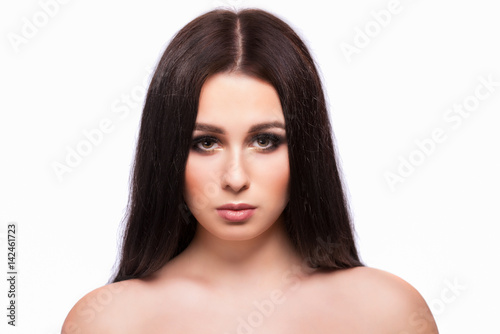 Beauty woman face portrait with clean fresh skin, long hair and bright evening make up.Isolated