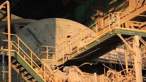 A ball Mill inside of a copper processing industry.
A ball mill, a type of grinder, is a cylindrical device used in grinding (or mixing) materials