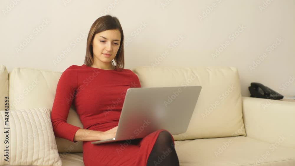 beautiful young woman uses a laptop in a hotel room beautiful young woman uses a laptop in a hotel room