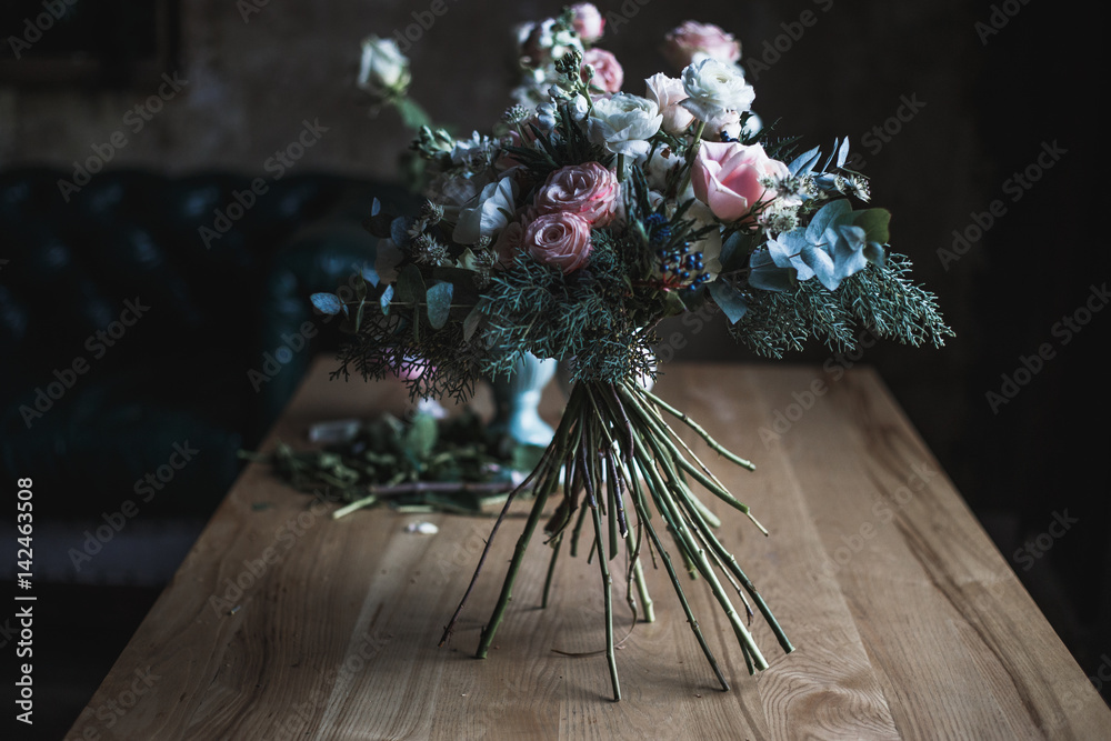 Florist workplace: flowers and accessories on a vintage wooden table. soft  focus. Modern bouquet in a vase on a table, simple composition Stock Photo  by ©cherry_daria 147713707