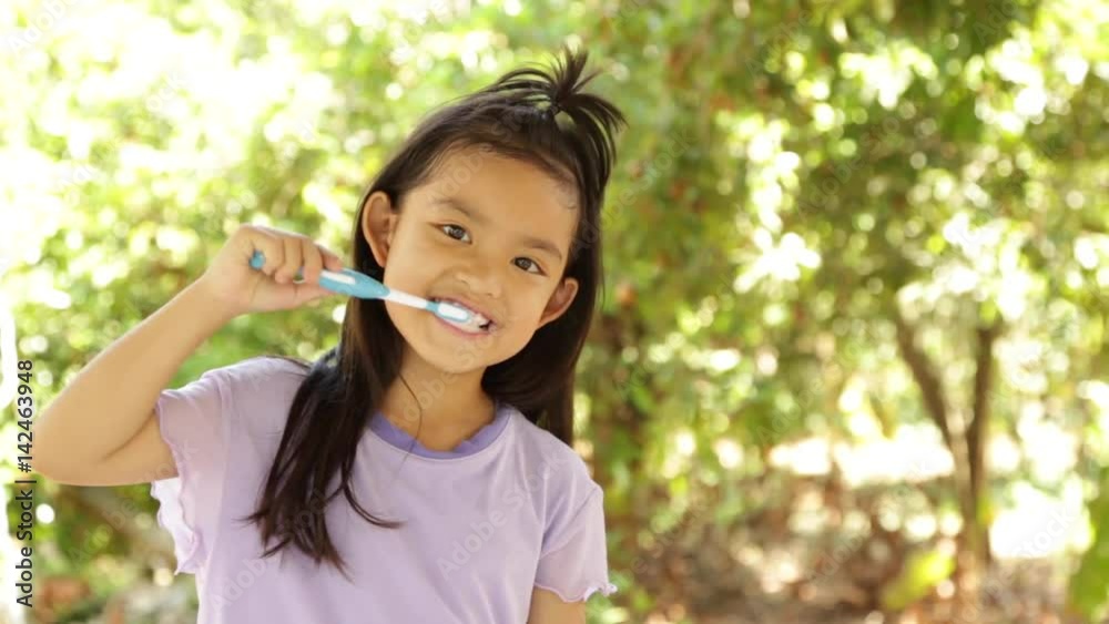 Cute Asian Little Girl Brushing Teeth after meal Cute Asian Little Girl Brushing Teeth after meal