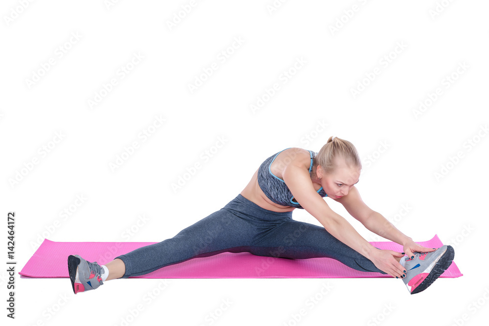 beautiful blonde woman does exercises on fitness Mat on white background. stretching beautiful blonde woman does exercises on fitness Mat on white background. stretching
