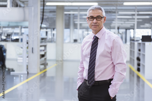 Portrait of a manager on shop floor of a factory