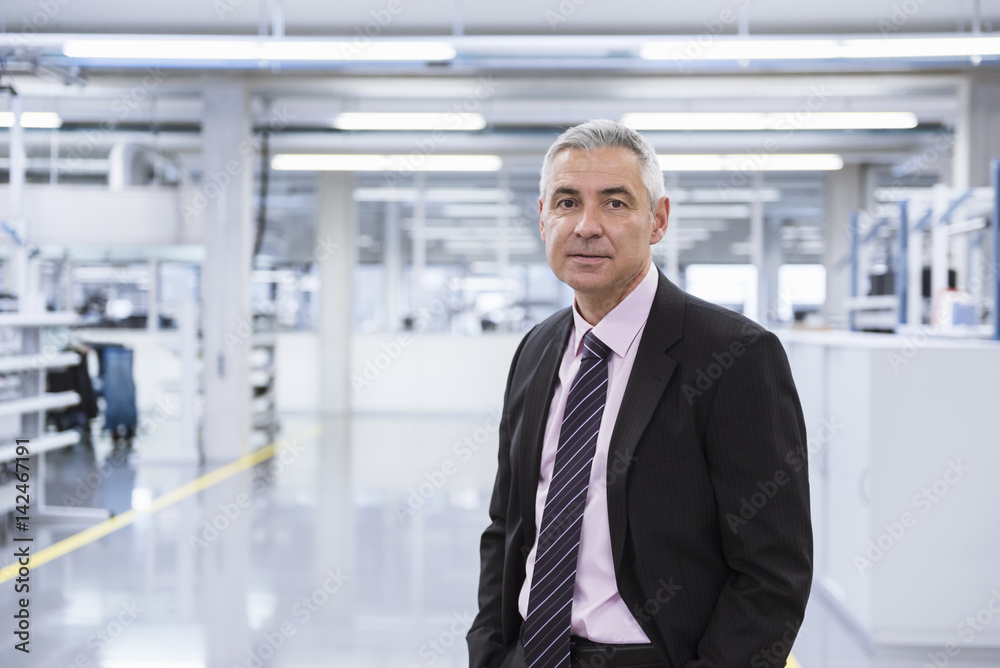 Manager at shop floor of a factory, portrait Manager at shop floor of a factory, portrait