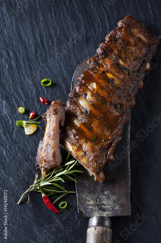 Marinated and grilled spare ribs with Barbecue sauce on slate