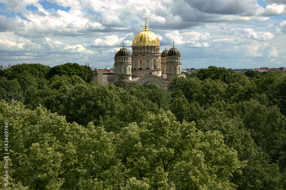 Orthodox church building above flourishing park