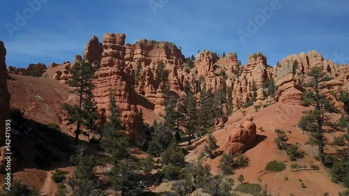 Aerial Bryce Canyon Red Canyon landscape climb forward. Red Canyon near the Park within Dixie National Forest in southwest Utah. Geological structures hoodoos formation weathering and water erosion.