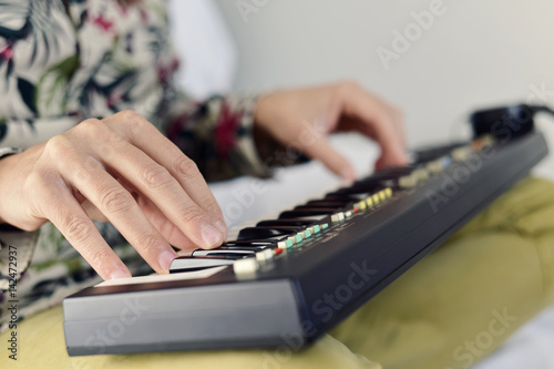 young man playing an electronic keyboard