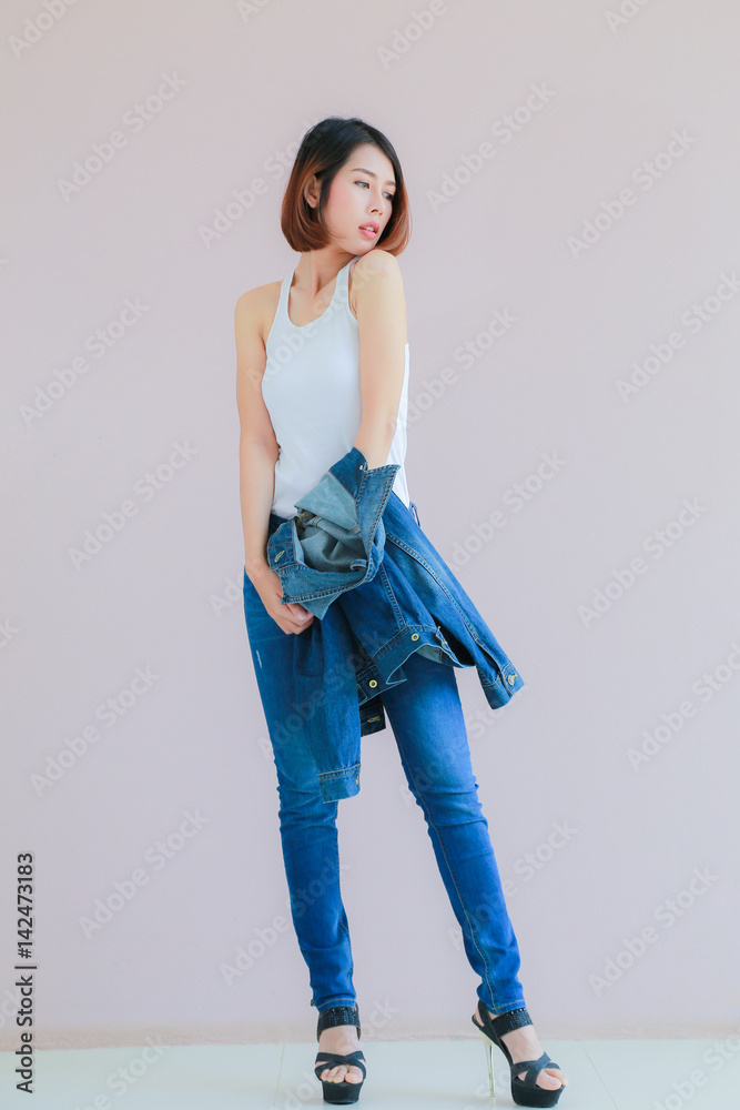Asian woman casual outfits standing in jeans and blue denim shirt, women  brown hair and short hair, smiling and wearing jeans jacket, beauty and  fashion Jeans concept, space wall background Stock Photo |