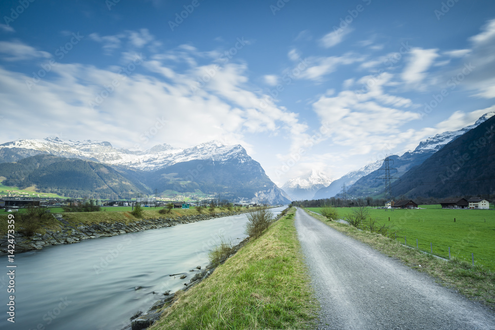 Canton of Uri. In the direction of Gotthard. Alpine landscape. The road and the river flows side by side. Long exposure.