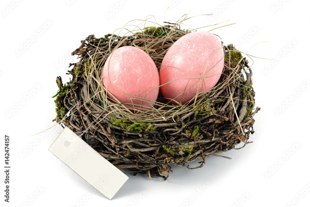pink easter eggs in a nest with copy space label on white isolated background pink easter eggs in a nest with copy space label on white isolated background