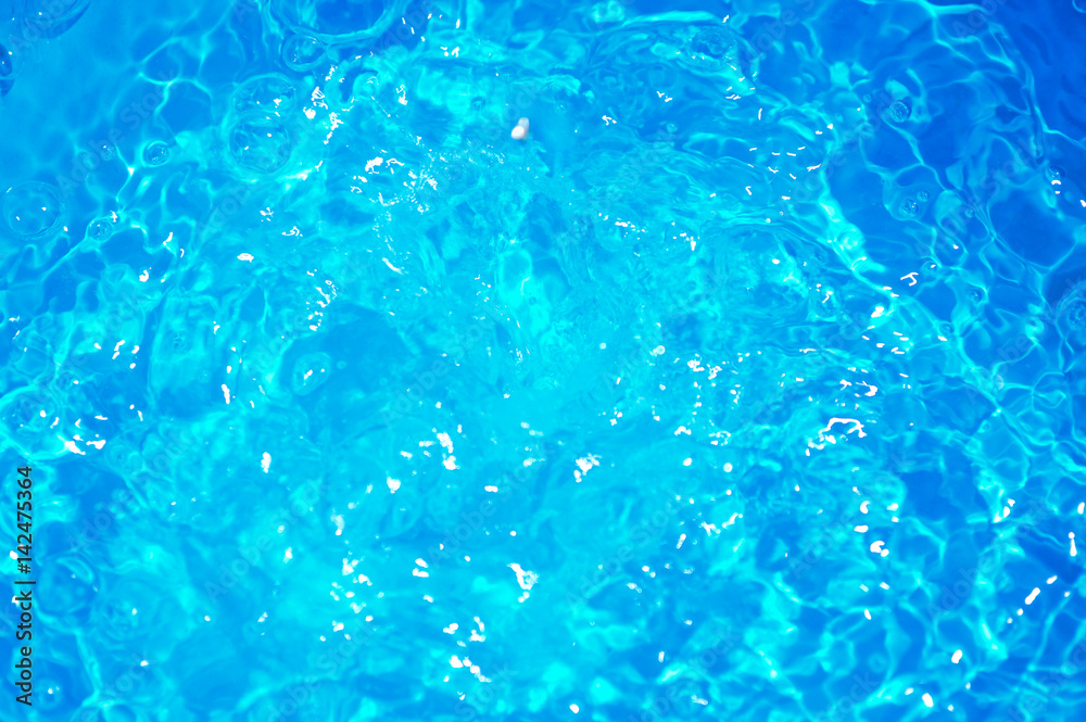 Blue pool water with sun reflections.Shining blue water ripple background. Blue pool water with sun reflections.Shining blue water ripple background.