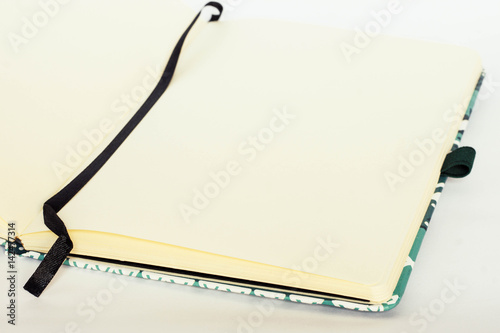 Notebook with bookmark and with blank pages on white background