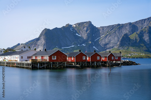 Panorama of mount Olstind above the red fishing houses called Rorbu in town of Hamnoy on Lofoten islands, Norway