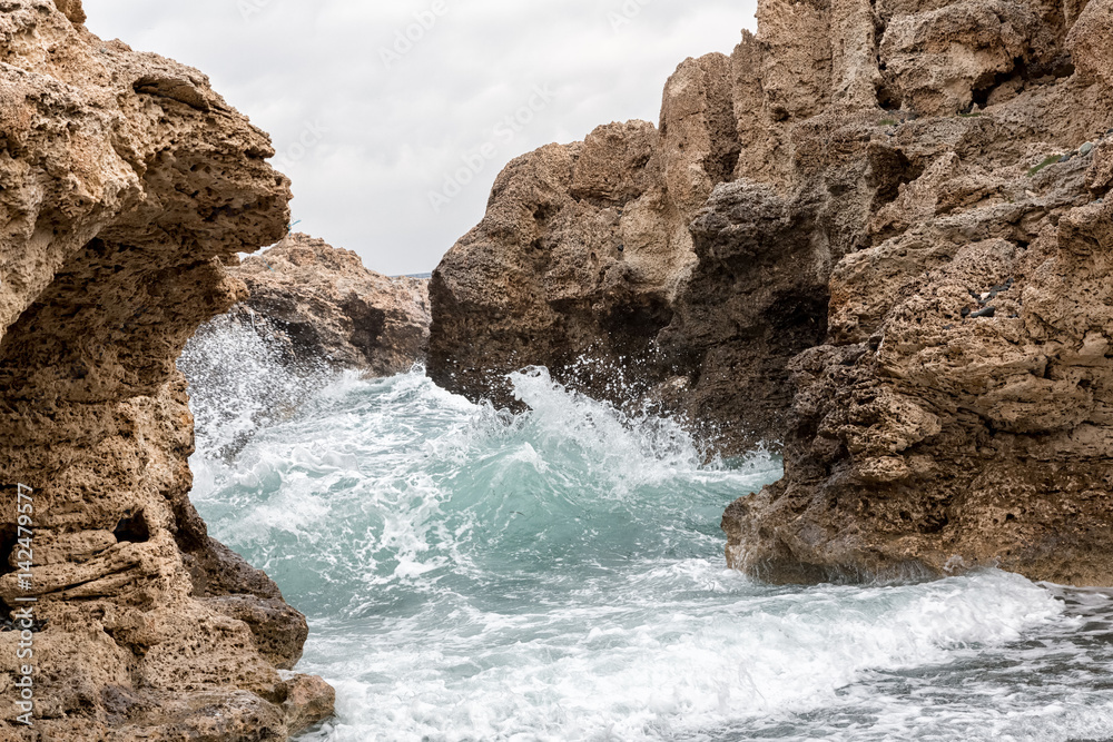 Mediterranean Sea waves breaking rocky coastline of Cyprus island
