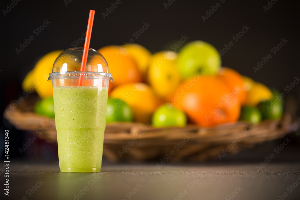 plastic glass to go, of fresh green smoothie made from mint, apple and spinach plastic glass to go, of fresh green smoothie made from mint, apple and spinach