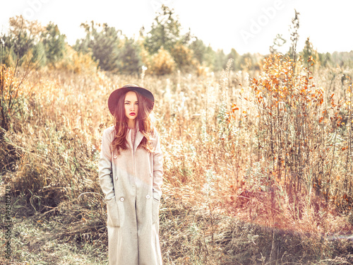 Fashion beautiful lady in autumn landscape