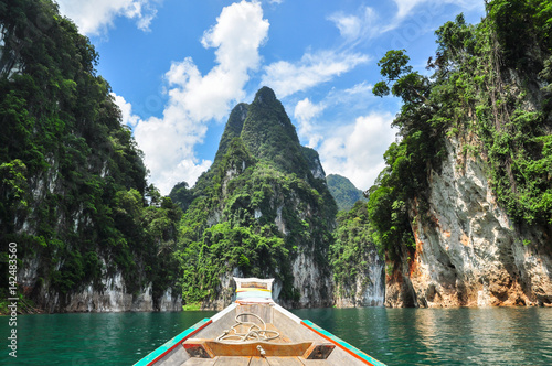 Huge limestone cliffs rising out of open lake at Khao Sok National Park, Ratchaprapha Dam in Surat Thani Province, Thailand.