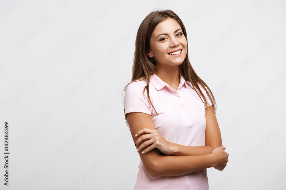 Portrait of smiling woman with arms across looking at camera Portrait of smiling woman with arms across looking at camera
