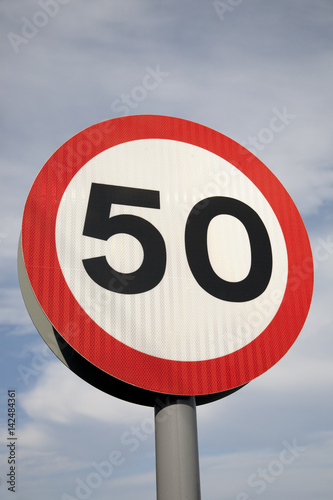 Fifty Speed Sign against Blue Sky Background