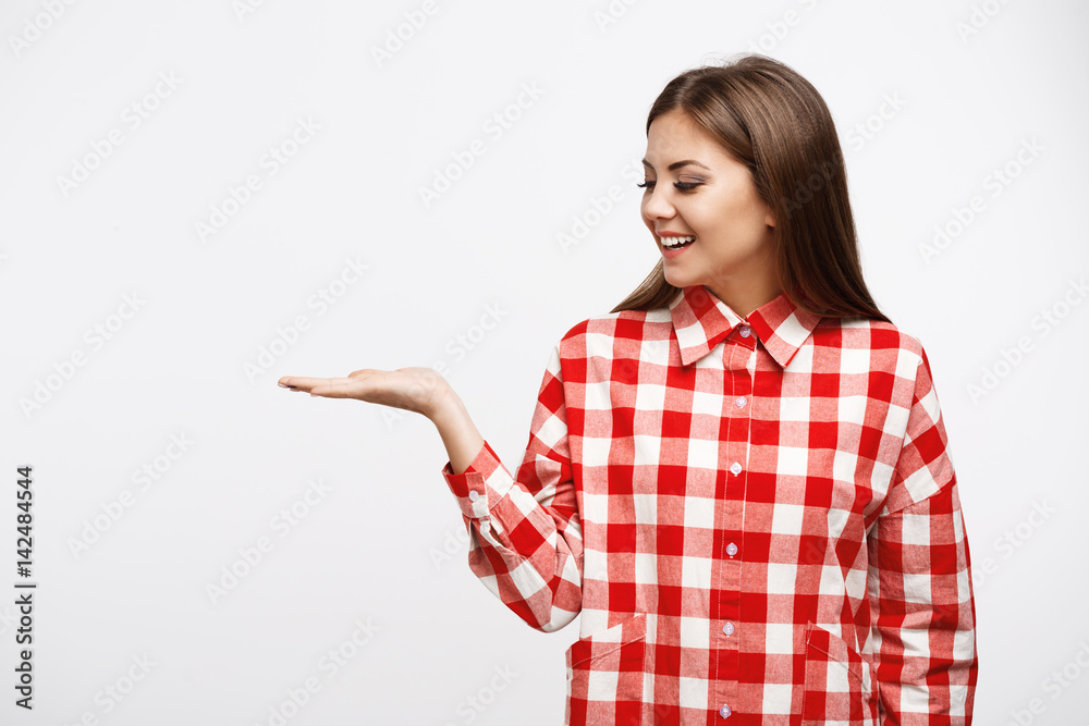 Closeup of attractive young woman in shirt with hand up Closeup of attractive young woman in shirt with hand up