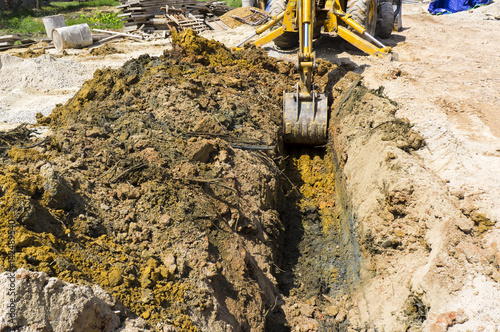 Digging hole for septic tank installation.