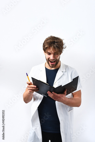 Bearded caucasian doctor or postgraduate student with clipboard and pen