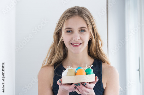 happy easter blonde girl with colorful painted eggs in box