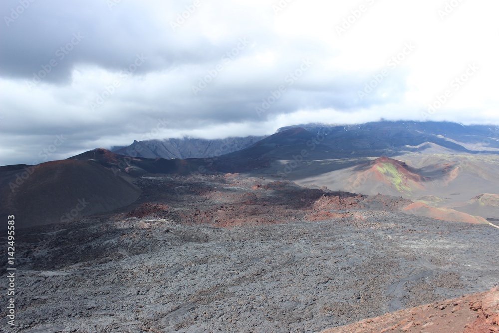 Black and red ash, valley of hills, after volcanic eruption