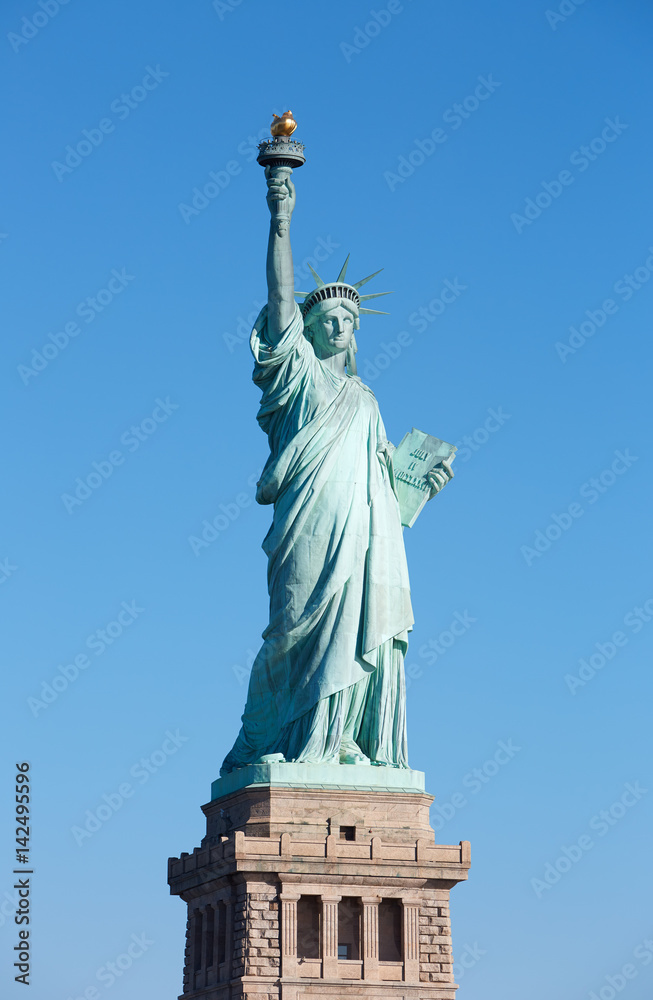 Fototapeta premium Statue of Liberty with pedestal in New York, clear blue sky in a sunny day, clipping path
