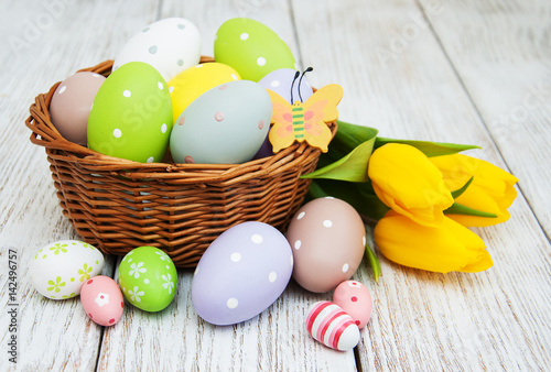 Basket with easter eggs and tulips