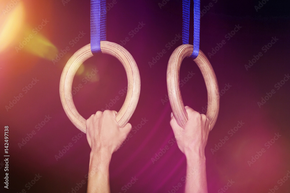 Sports, gymnastics Two hands clutch traditional wooden gymnastic rings