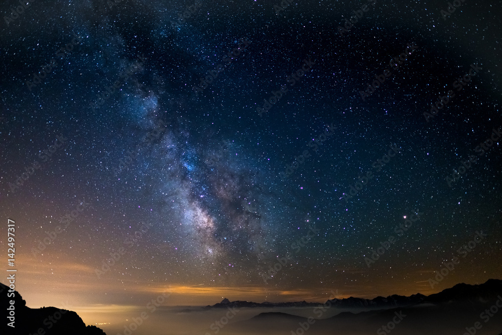 Naklejka premium The outstanding beauty of the Milky Way arc and the starry sky reflected on lake at high altitude on the Alps. Fisheye scenic distortion and 180 degree view.