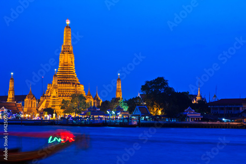 Wat Arun Ratchawararam Ratchawaramahawihan or Wat Arun besides Chao Praya river in Bangkok of Thailand