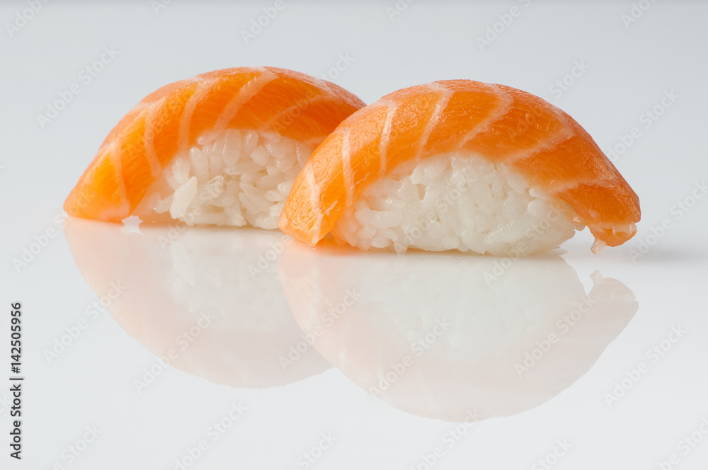 close up of sushi with rice on white background with reflection