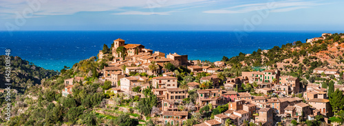 Beautiful landscape scenery with view of the old mediterranean village Deia on Majorca Spain island photo