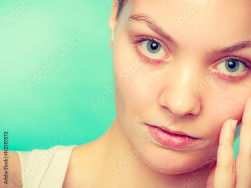 Woman in facial peel off mask.