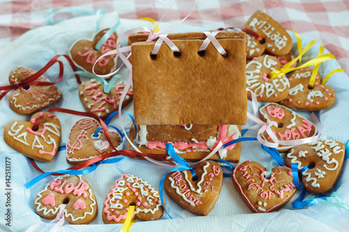 Homemade gingerbread house and decorated gingerbread hearts for wedding and Valentine's day.