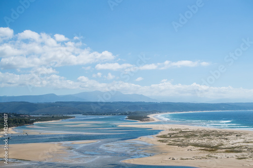 Fototapeta Naklejka Na Ścianę i Meble -  Beach and Coastline with Inlet and Houses Seen from a Lookout at Plettenberg Bay in South Africa