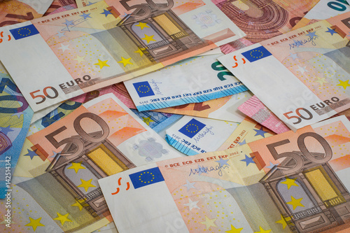 Different euro notes spread on a table