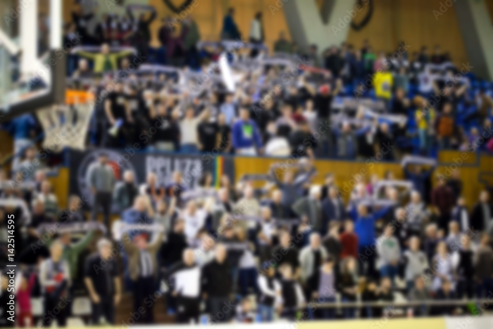 Naklejka premium blurred background of crowd of people in a basketball court