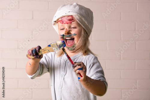 Little girl playing with bright colors photo