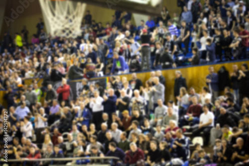 blurred background of crowd of people in a basketball court © Melinda Nagy