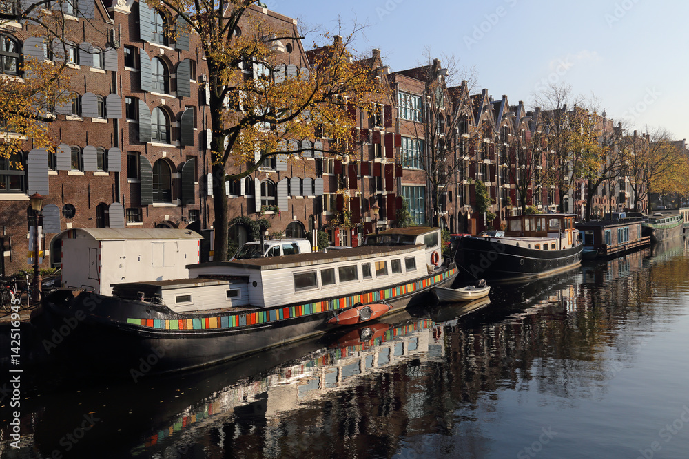 Canal boats in autumn in Amsterdam, Holland