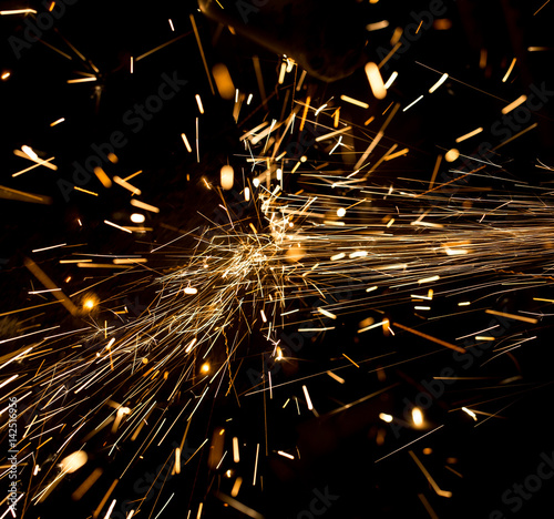 Sparks from metal on construction site as background