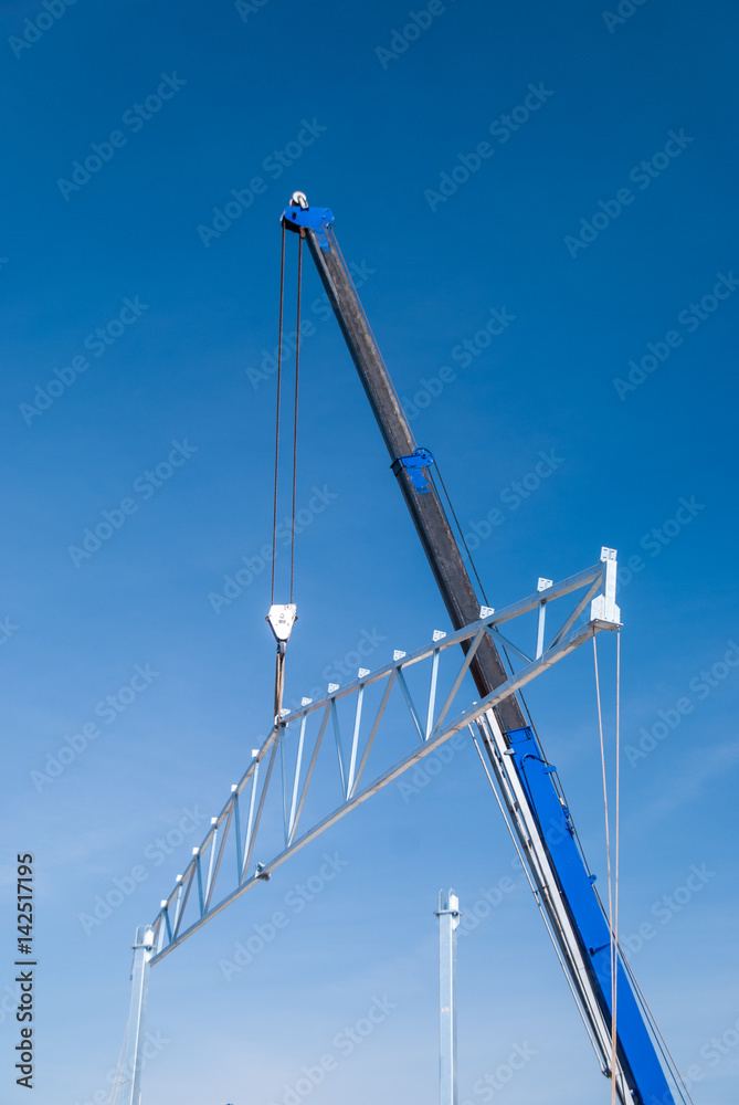 Crane lifting galvanized steel roof truss construction frames with deep