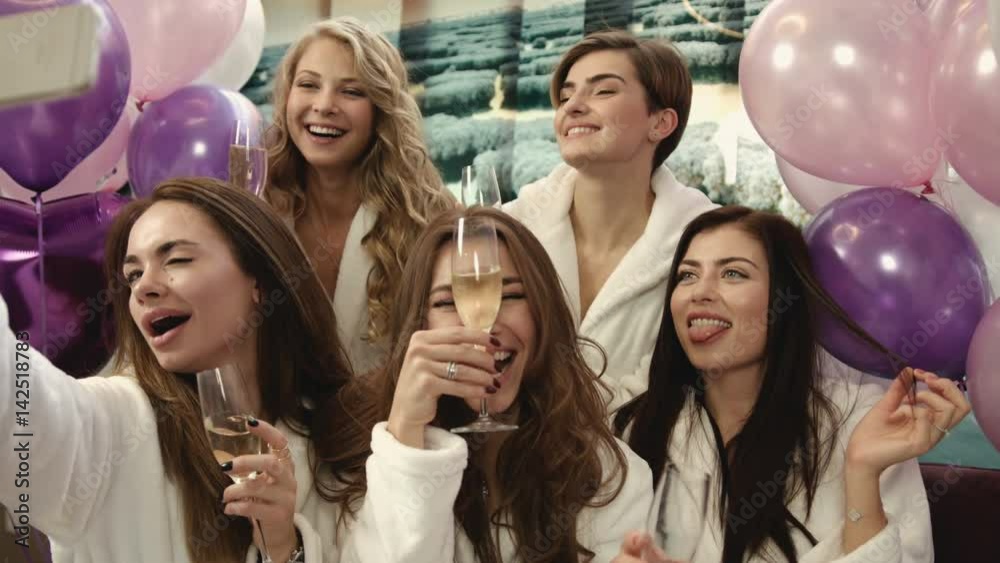 Group of beautiful girls sitting at the beauty salon and taking selfies. Smiling women having good time in spa salon. Group of beautiful girls sitting at the beauty salon and taking selfies. Smiling women having good time in spa salon.