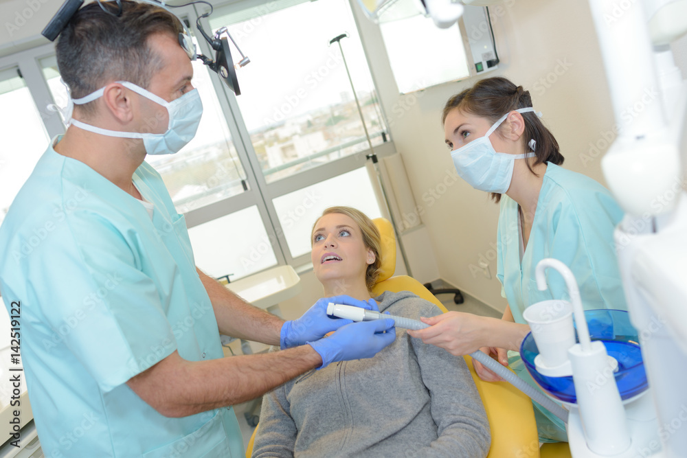 Dentist holding suction hose Dentist holding suction hose