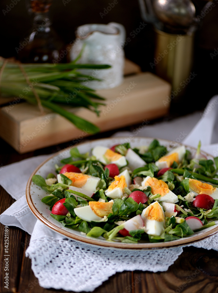 Spring green salad from organic radish, wild garlic with boiled eggs, olive oil and parmesan.